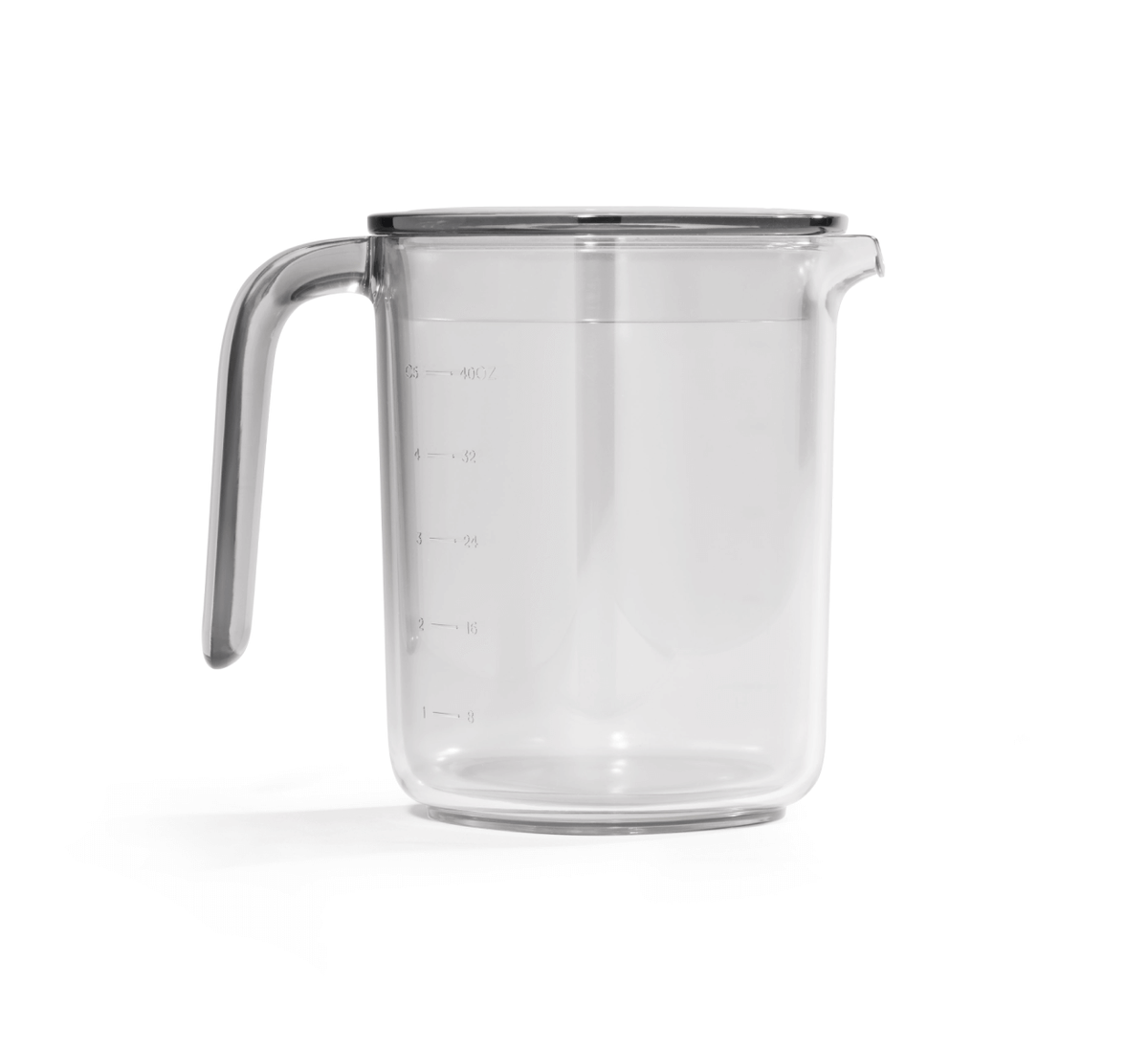 The Juice and Pulp Container Set is a clear glass measuring cup featuring a handle, spout, and easy-to-read measurement markings on the side—ideal for use as a juice container when pouring from your cold press juicer. Shown isolated on a white background.