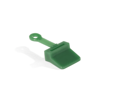 A green plastic Pulp Outlet Gasket with a circular hole in the handle is placed next to a Nama J3 Cold Press Juicer on a white background.