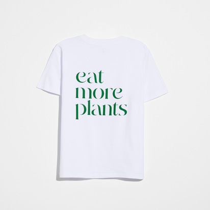 The Eat More Plants T-shirt, made from 100% combed cotton, is shown flat with green "eat more plants" text on the back.