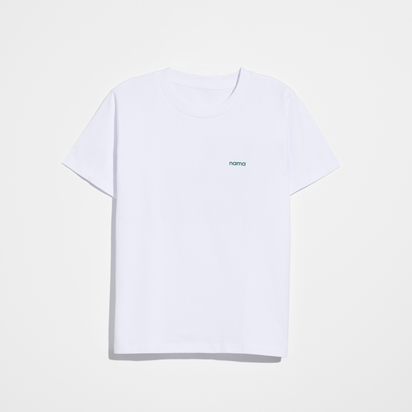 The Eat More Plants T-shirt is a plain white, relaxed fit tee made from 100% combed cotton, featuring "Eat More Plants" in small green letters on the left chest, displayed on a white background.