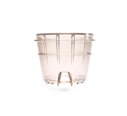 The Sorbet Strainer is a transparent, slightly tinted plant pot with vertical grooves and raised feet, photographed against a white background—ideal for growing herbs to complement frozen desserts or fresh juices.
