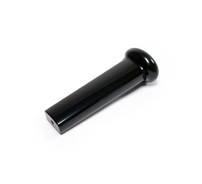 A glossy black cylindrical Pusher with a rounded top and a small hole near the flat end, designed for use with the Nama Vitality 5800 Cold Press Juicer, is photographed on a white background.