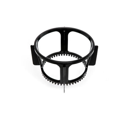 A black, circular plastic Spinning Brush for the Nama Vitality 5800 Cold Press Juicer features four open sides, vertical supports, and small teeth along the inner bottom edge, shown from above against a white background.