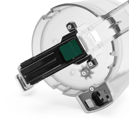 Close-up of the Pulp Outlet Gasket from the Nama J2 Cold Press Juicer, showing its transparent plastic design, black and green locking mechanism, visible screws, and placement at the pulp outlet.