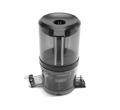 The Chamber Set is a transparent and black plastic juice strainer attachment with a cylindrical design, handle, and dual spouts for juice and pulp. It's compatible with the Nama J2 Cold Press Juicer and is shown isolated on a white background.